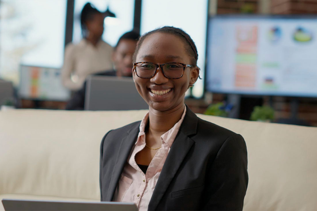 Woman in a suit smiling at the camera