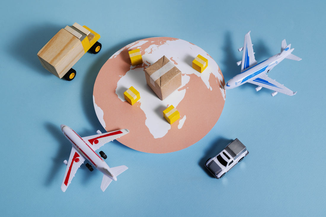 Collection of logistics methods/vehicles on blue paper backdrop