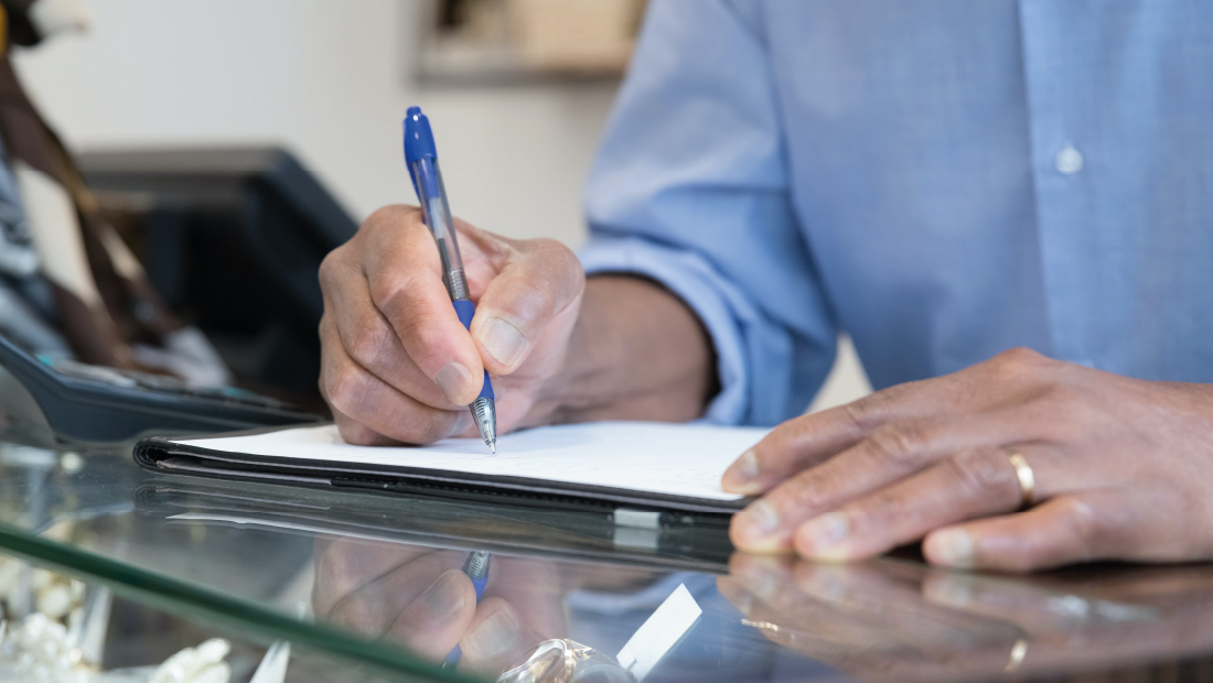 Close-up of Man Writing on Paper